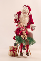 Image showing Christmas portrait of cute little newborn baby girl, dressed in christmas clothes, studio shot, winter time