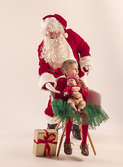 Image showing Christmas portrait of cute little newborn baby girl, dressed in christmas clothes, studio shot, winter time