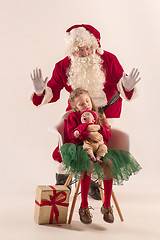 Image showing Christmas portrait of cute little newborn baby girl, dressed in christmas clothes, studio shot, winter time