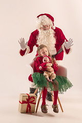 Image showing Christmas portrait of cute little newborn baby girl, dressed in christmas clothes, studio shot, winter time