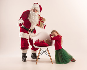 Image showing Christmas portrait of cute little newborn baby girl, dressed in christmas clothes, studio shot, winter time