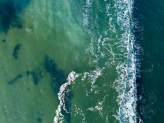 Image showing Abstract turquoise sea water with white foam waves for natural background. Aerial top view from drone above ocean. Copy space.