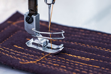 Image showing Professional sewing machine close-up. Modern textile industry.