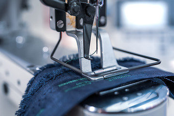 Image showing Professional sewing machine close-up. Modern textile industry.