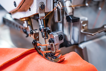 Image showing Professional sewing machine close-up. Modern textile industry.