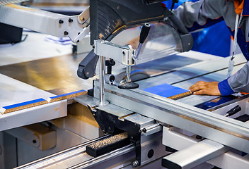 Image showing Carpenter worker operating wood cutting machine. CNC woodworking