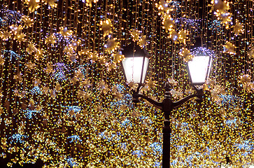 Image showing Street lantern with decorative Christmas garlands. New year and 