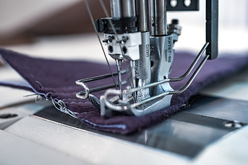 Image showing Professional sewing machine close-up. Modern textile industry.