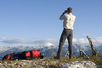 Image showing Mountaineer looking through field glasses