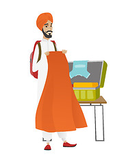 Image showing Hindu traveler man packing suitcase.