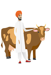 Image showing Farmer standing with crossed arms near cow.