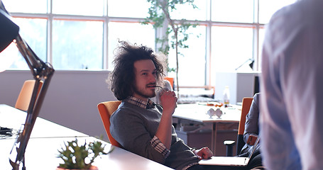 Image showing businessman working using a laptop in startup office