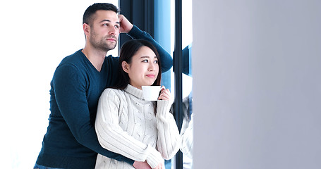 Image showing multiethnic couple relaxing at modern home indoors