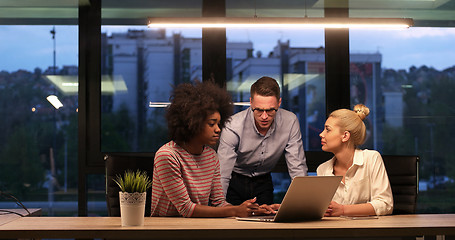 Image showing Multiethnic startup business team in night office