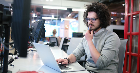 Image showing businessman working using a laptop in startup office