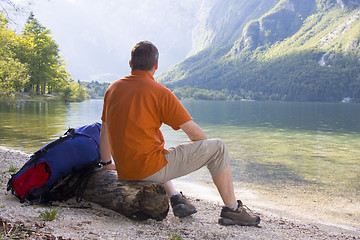 Image showing Hiker relaxing at a mountain lake