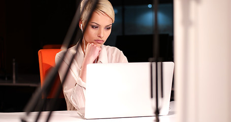 Image showing woman working on laptop in night office