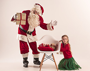 Image showing Christmas portrait of cute little newborn baby girl, dressed in christmas clothes, studio shot, winter time