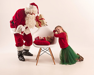 Image showing Christmas portrait of cute little newborn baby girl, dressed in christmas clothes, studio shot, winter time