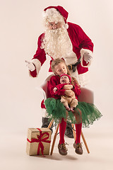 Image showing Christmas portrait of cute little newborn baby girl, dressed in christmas clothes, studio shot, winter time