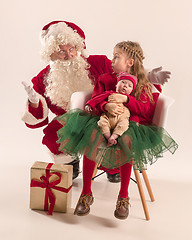 Image showing Christmas portrait of cute little newborn baby girl, dressed in christmas clothes, studio shot, winter time