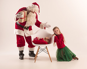 Image showing Christmas portrait of cute little newborn baby girl, dressed in christmas clothes, studio shot, winter time