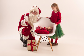 Image showing Christmas portrait of cute little newborn baby girl, dressed in christmas clothes, studio shot, winter time