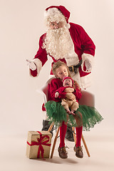 Image showing Christmas portrait of cute little newborn baby girl, dressed in christmas clothes, studio shot, winter time