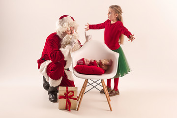 Image showing Christmas portrait of cute little newborn baby girl, dressed in christmas clothes, studio shot, winter time