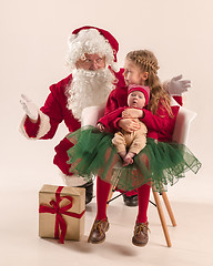 Image showing Christmas portrait of cute little newborn baby girl, dressed in christmas clothes, studio shot, winter time