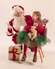 Image showing Christmas portrait of cute little newborn baby girl, dressed in christmas clothes, studio shot, winter time