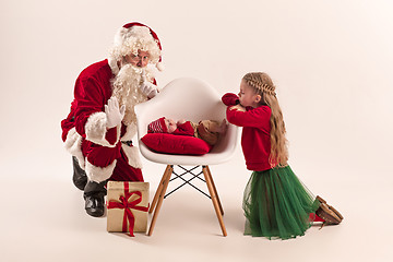 Image showing Christmas portrait of cute little newborn baby girl, dressed in christmas clothes, studio shot, winter time