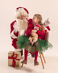 Image showing Christmas portrait of cute little newborn baby girl, dressed in christmas clothes, studio shot, winter time