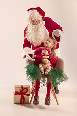 Image showing Christmas portrait of cute little newborn baby girl, dressed in christmas clothes, studio shot, winter time