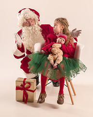 Image showing Christmas portrait of cute little newborn baby girl, dressed in christmas clothes, studio shot, winter time