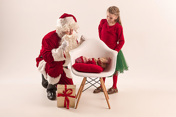 Image showing Christmas portrait of cute little newborn baby girl, dressed in christmas clothes, studio shot, winter time