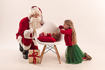 Image showing Christmas portrait of cute little newborn baby girl, dressed in christmas clothes, studio shot, winter time