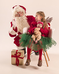 Image showing Christmas portrait of cute little newborn baby girl, dressed in christmas clothes, studio shot, winter time