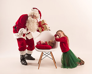 Image showing Christmas portrait of cute little newborn baby girl, dressed in christmas clothes, studio shot, winter time