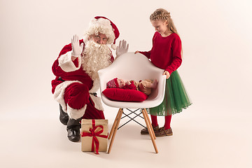 Image showing Christmas portrait of cute little newborn baby girl, dressed in christmas clothes, studio shot, winter time