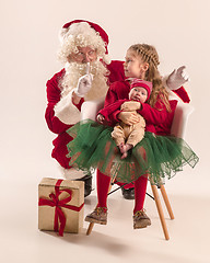 Image showing Christmas portrait of cute little newborn baby girl, dressed in christmas clothes, studio shot, winter time