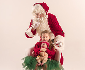 Image showing Christmas portrait of cute little newborn baby girl, dressed in christmas clothes, studio shot, winter time