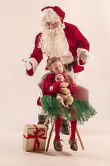 Image showing Christmas portrait of cute little newborn baby girl, dressed in christmas clothes, studio shot, winter time