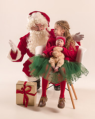 Image showing Christmas portrait of cute little newborn baby girl, dressed in christmas clothes, studio shot, winter time