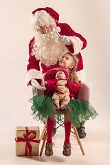 Image showing Christmas portrait of cute little newborn baby girl, dressed in christmas clothes, studio shot, winter time