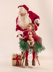 Image showing Christmas portrait of cute little newborn baby girl, dressed in christmas clothes, studio shot, winter time