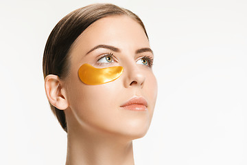 Image showing Beauty portrait of an attractive girl with a gold patch under the eye.