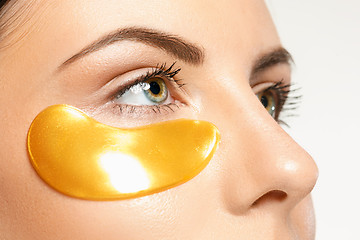 Image showing Beauty portrait of an attractive girl with a gold patch under the eye.