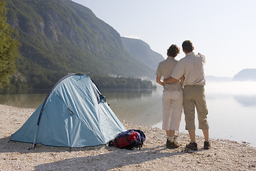 Image showing Couple beside a tent at a mountain lake