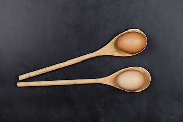 Image showing Eggs in wooden spoons.